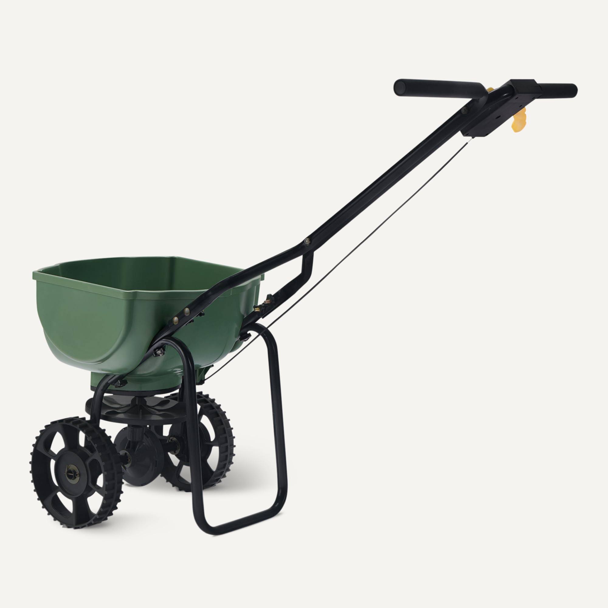 Amazon Basics spreader in use distributing seed evenly across grass