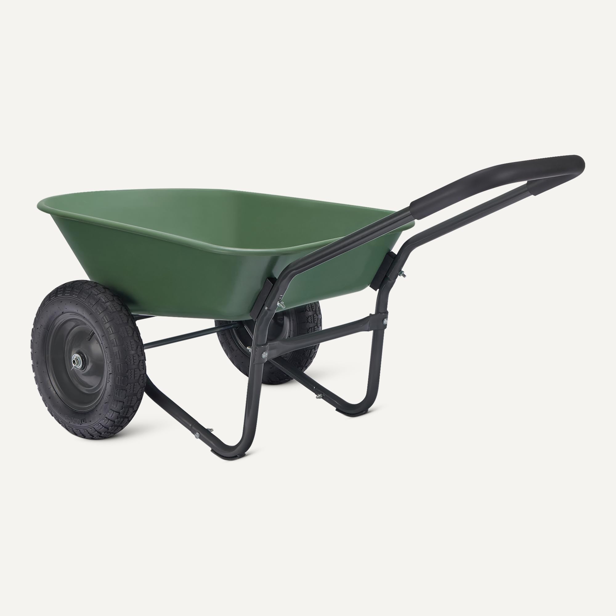 Amazon Basics wheelbarrow loaded in a garden being pushed, for practical yardwork use