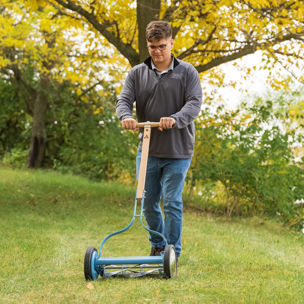 American Lawn Mower Company next to person showing lightweight size and easy pushability