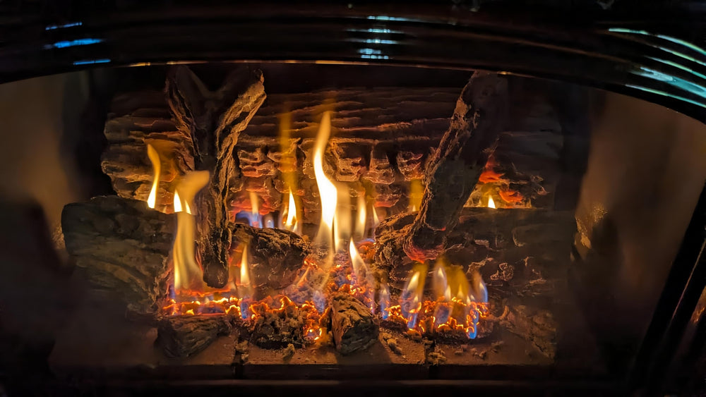 Americangaslogs burner pan in a lit fireplace setting showing realistic flames