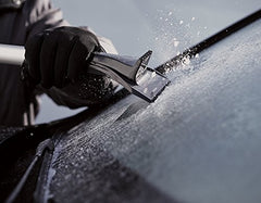 AMES brush in use clearing snow from an SUV roof for faster, safer removal