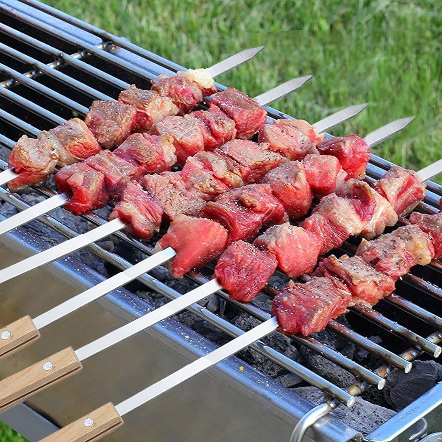 Amestar skewers beside a ruler showing 23.5-inch length for large kebabs