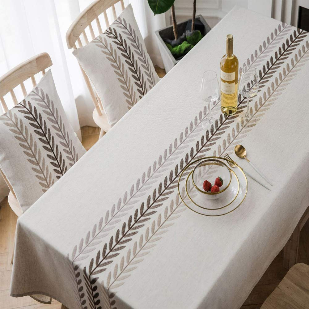 AMZALI tablecloth next to chairs for scale showing true 53 x 87 inch fit