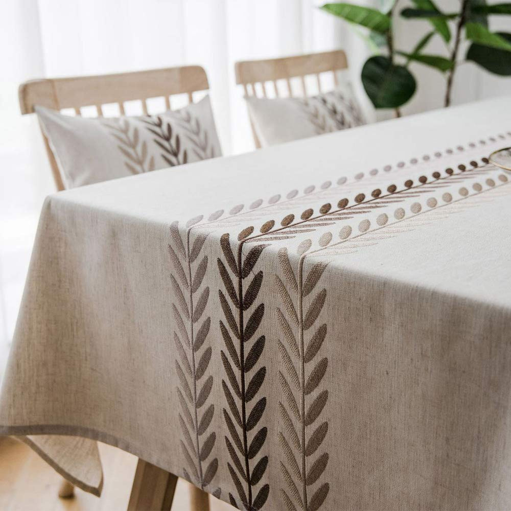 AMZALI tablecloth styled with dinnerware demonstrating polished dining presentation