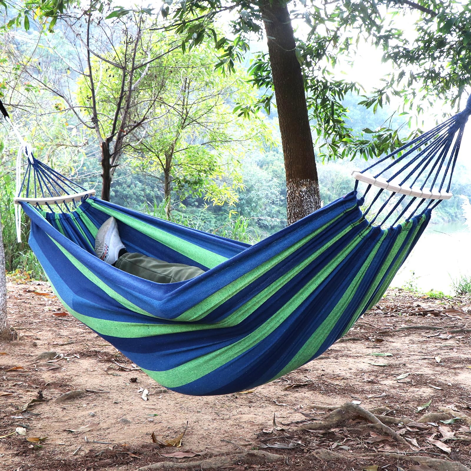 ANYOO hammock near people for size scale showing roomy 7ft by 5ft benefit