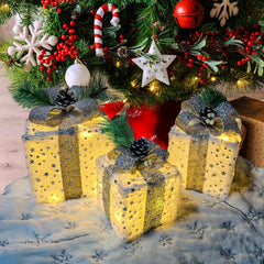 Aokudoni three plush gift boxes front view with warm lights creating cozy ambience