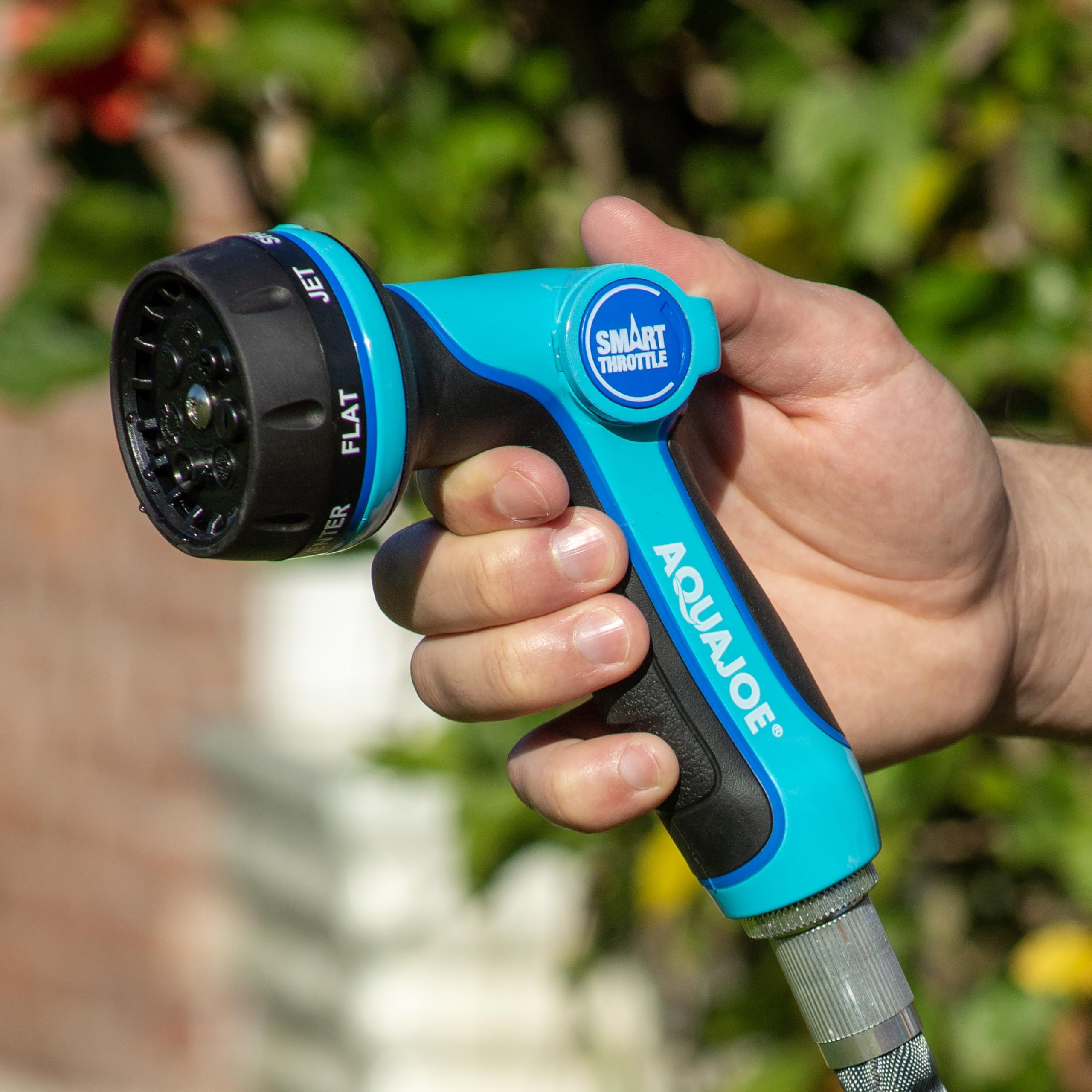 Aqua Joe nozzle spraying focused jet stream showing high-pressure cleaning power