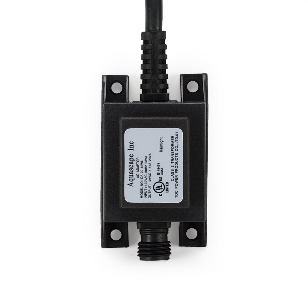 Aquascape transformer installed beside pond and waterfall providing reliable low-voltage lighting