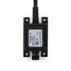 Aquascape transformer installed beside pond and waterfall providing reliable low-voltage lighting