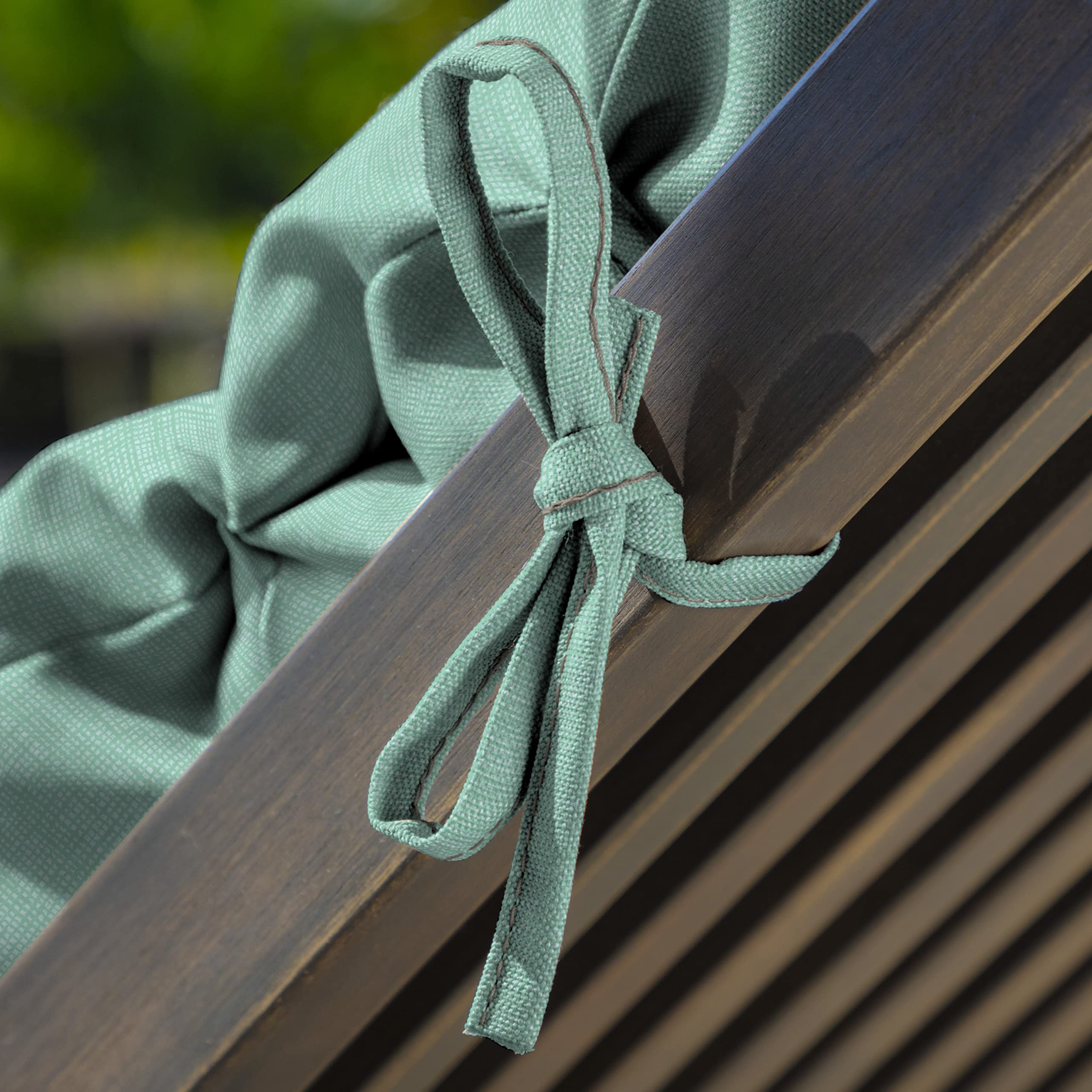 Arden Selections lifestyle patio scene with cushion creating inviting outdoor relaxation