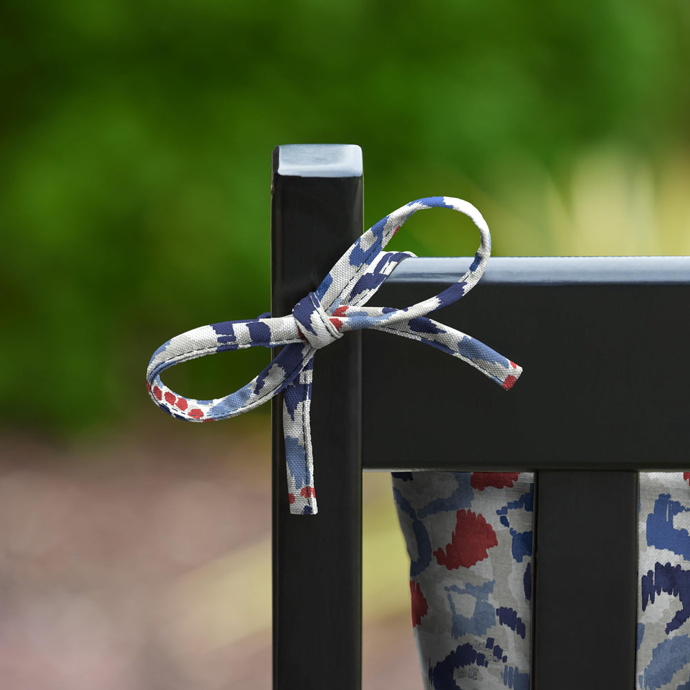 Arden Selections cushion on a porch rocker in lifestyle scene creating cozy outdoor seating