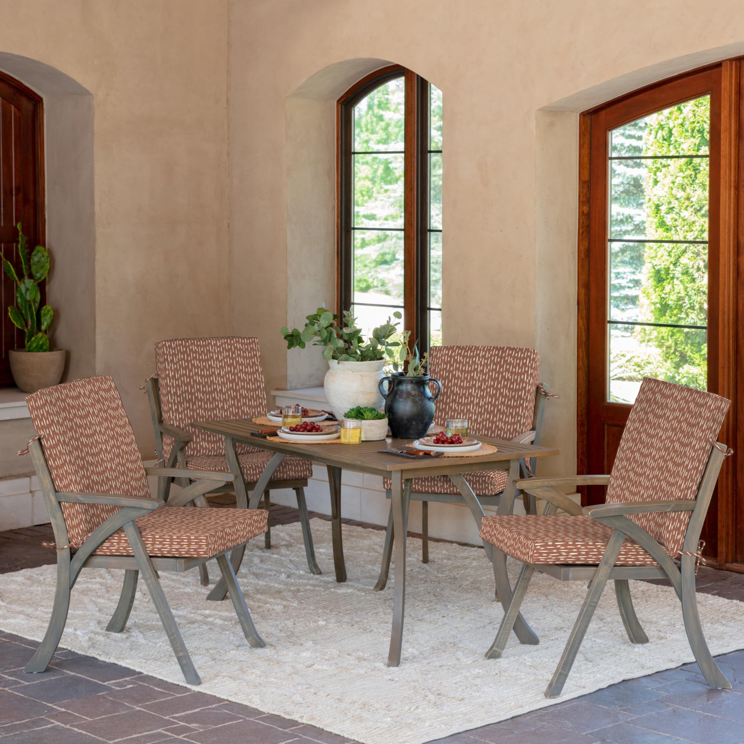 Arden Selections cushions installed on wooden dining chairs for styled patio seating