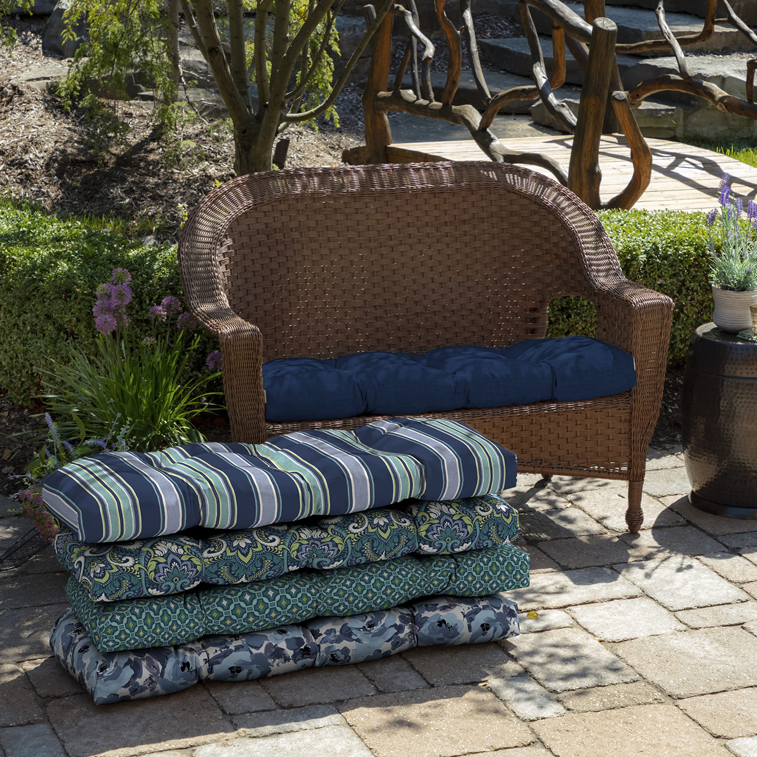 Arden Selections cushion on outdoor wicker settee showing comfortable patio seating