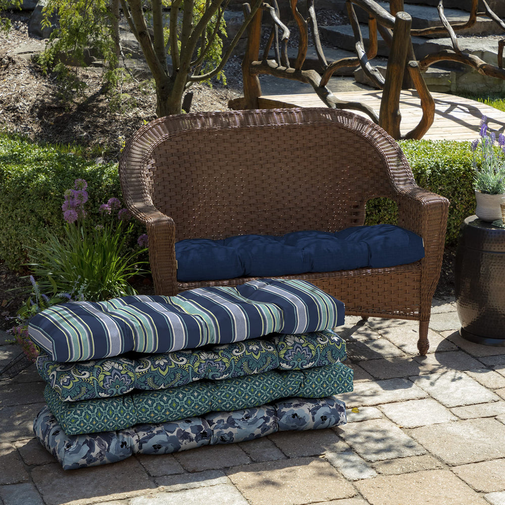 Arden Selections cushion on outdoor wicker settee showing comfortable patio seating
