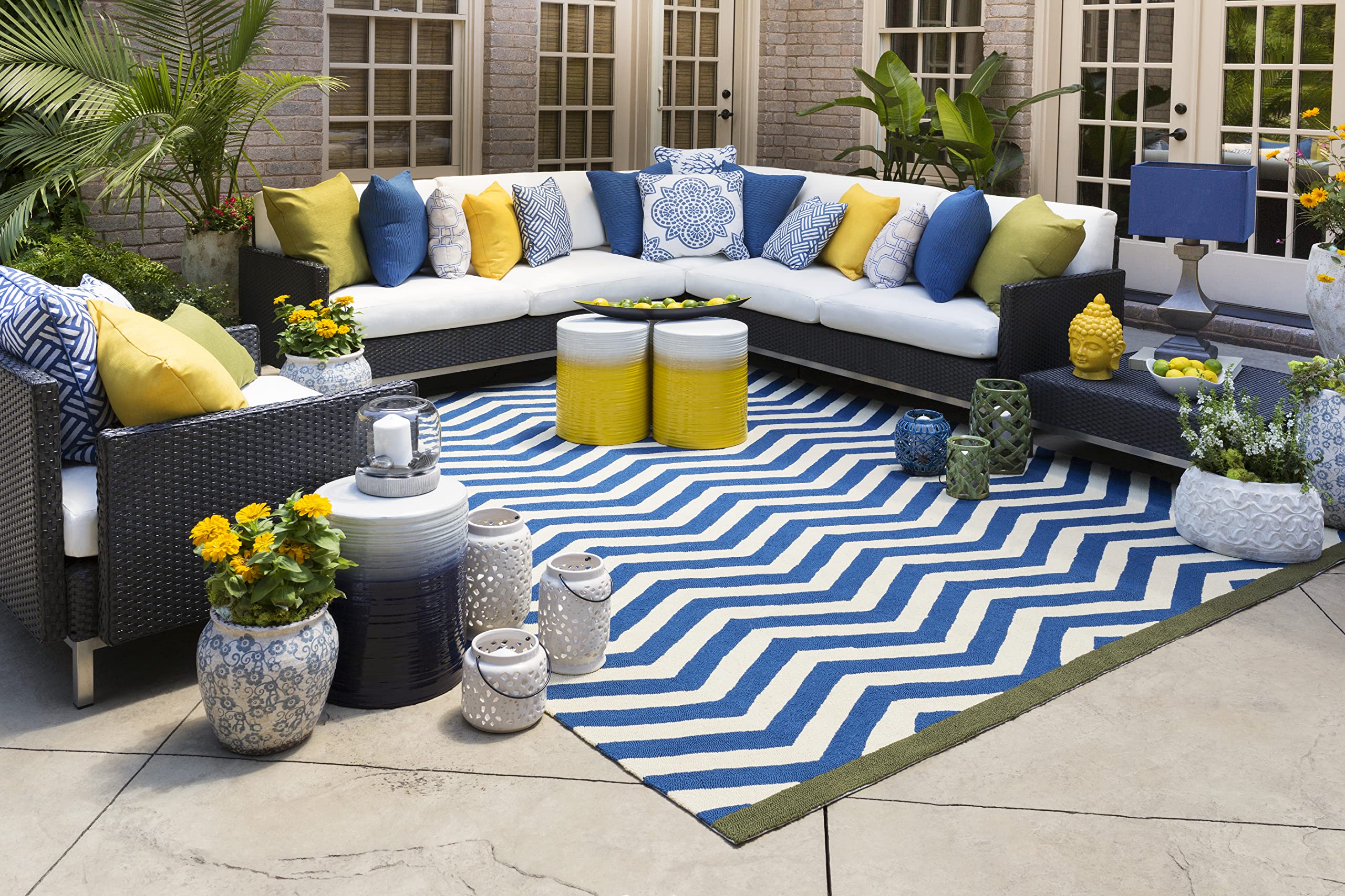 Artistic Weavers Reese on a covered patio used as side table and plant stand for styling