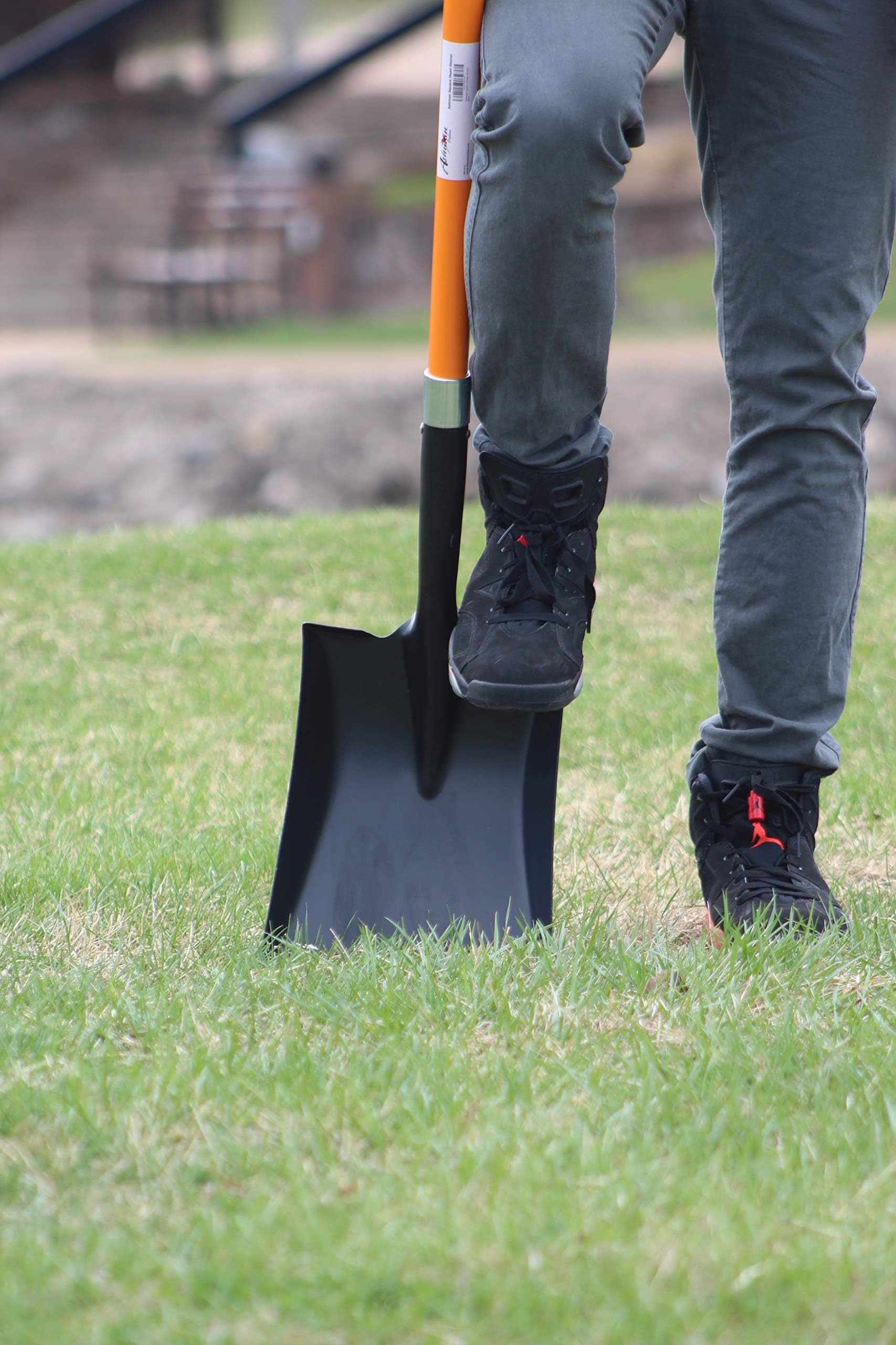 Ashman shovel mixing concrete in wheelbarrow for construction tasks