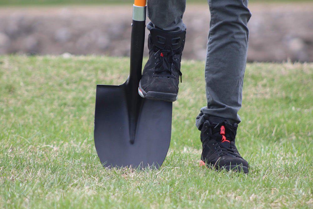 Ashman shovel digging into packed soil demonstrating strong cutting performance