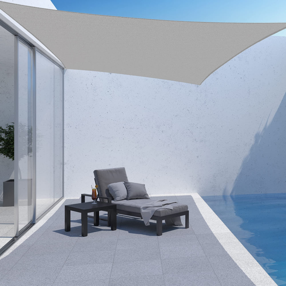AsterOutdoor gray shade sail installed over a patio providing cooled outdoor area
