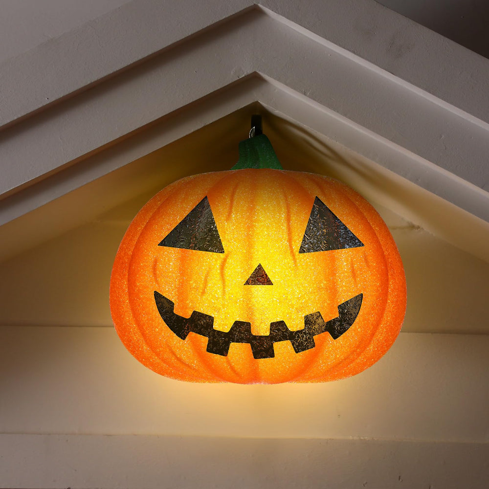 Aurelema glowing pumpkin cover at night creating visible jack-o'-lantern curb appeal