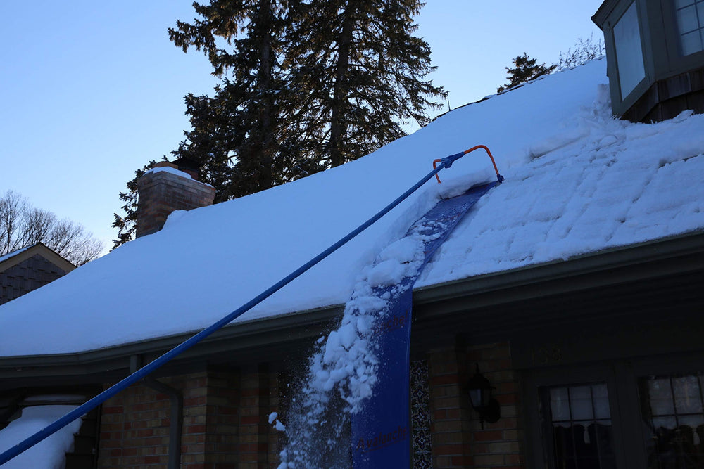 Avalanche! rake sliding over tile and solar panel demonstrating roof-friendly performance