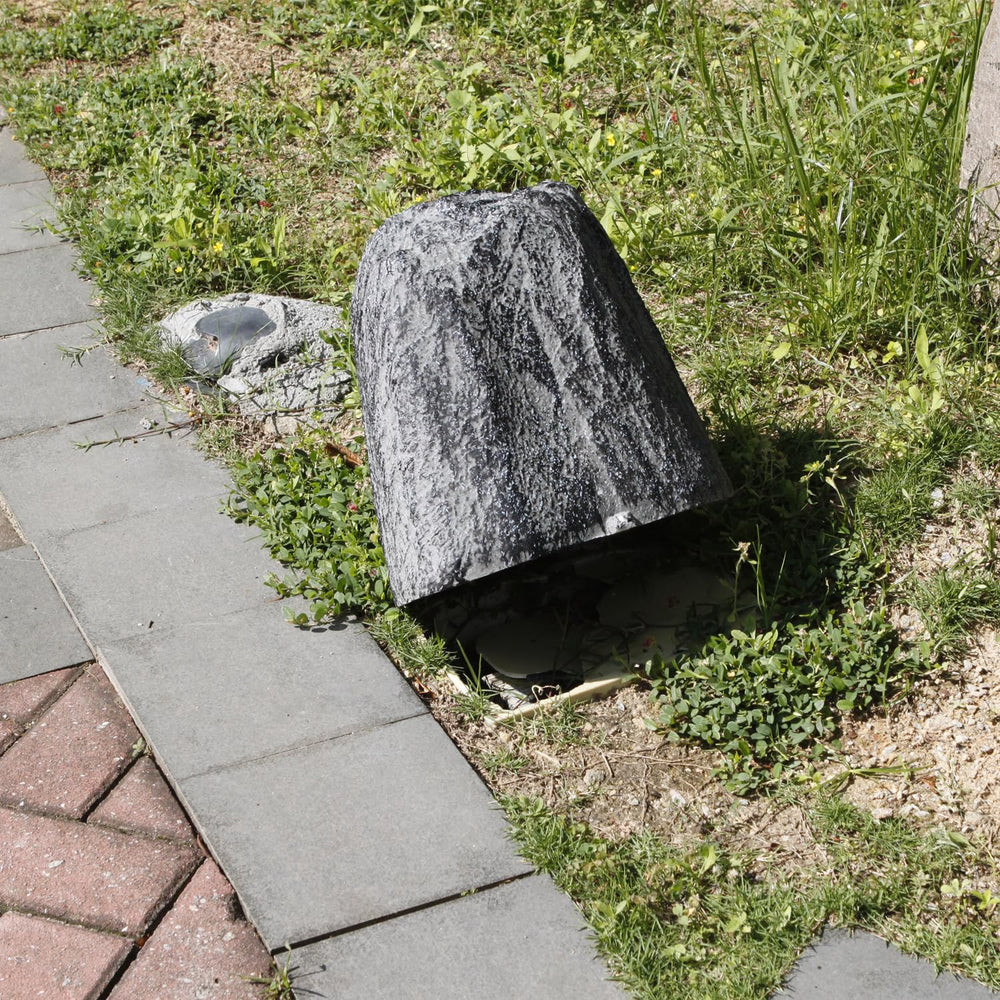 Aytupotin in use covering a sprinkler valve for tidy garden appearance