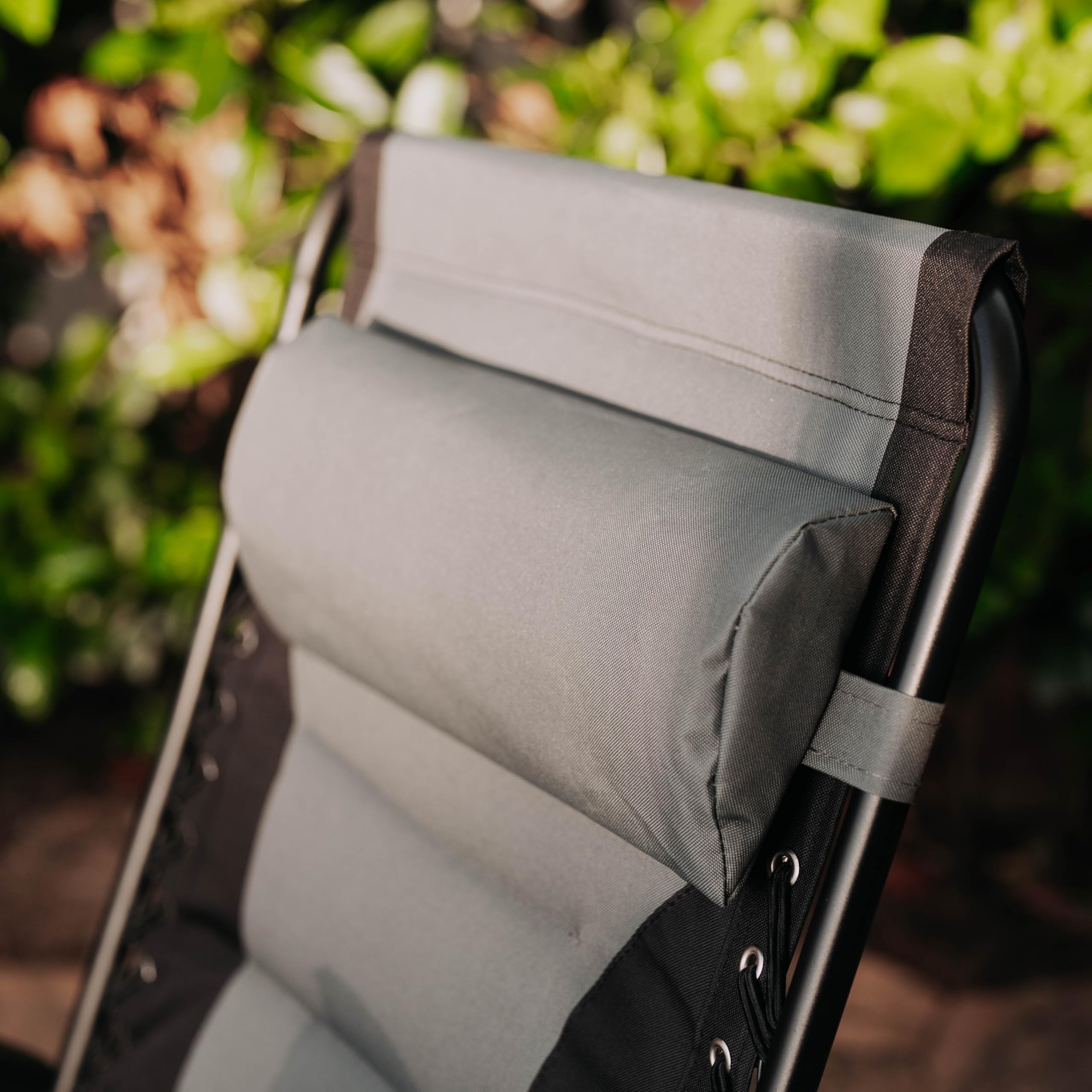 Backyard Expressions recliner with person for scale showing roomy 21-inch seat benefit