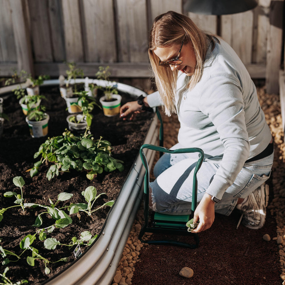 Backyard Expressions in-use image of gardener kneeling using seat to reduce joint strain