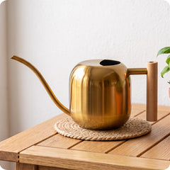 Baffect front view of gold watering can showing elegant shape and finish