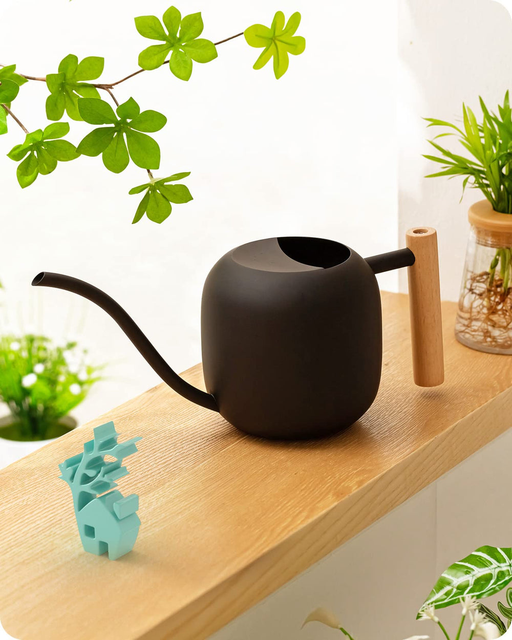 Baffect matte black watering can front view with elegant shelf display benefit