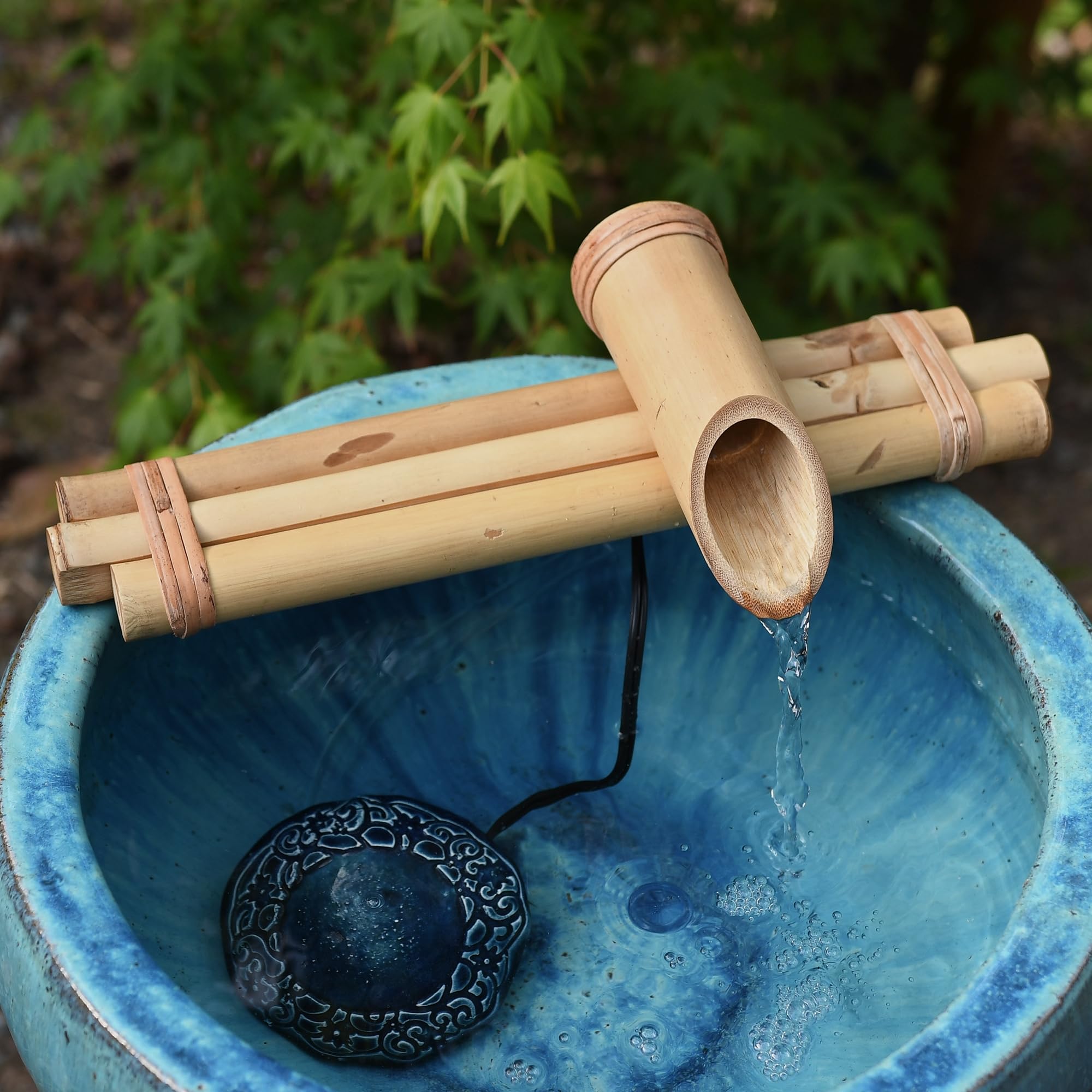 Bamboo Accents installed in stone basin creating a tranquil focal point