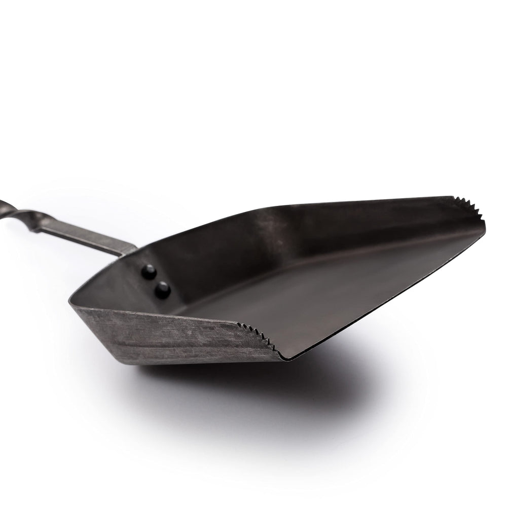 Barebones shovel in use moving coals to redistribute heat quickly and safely