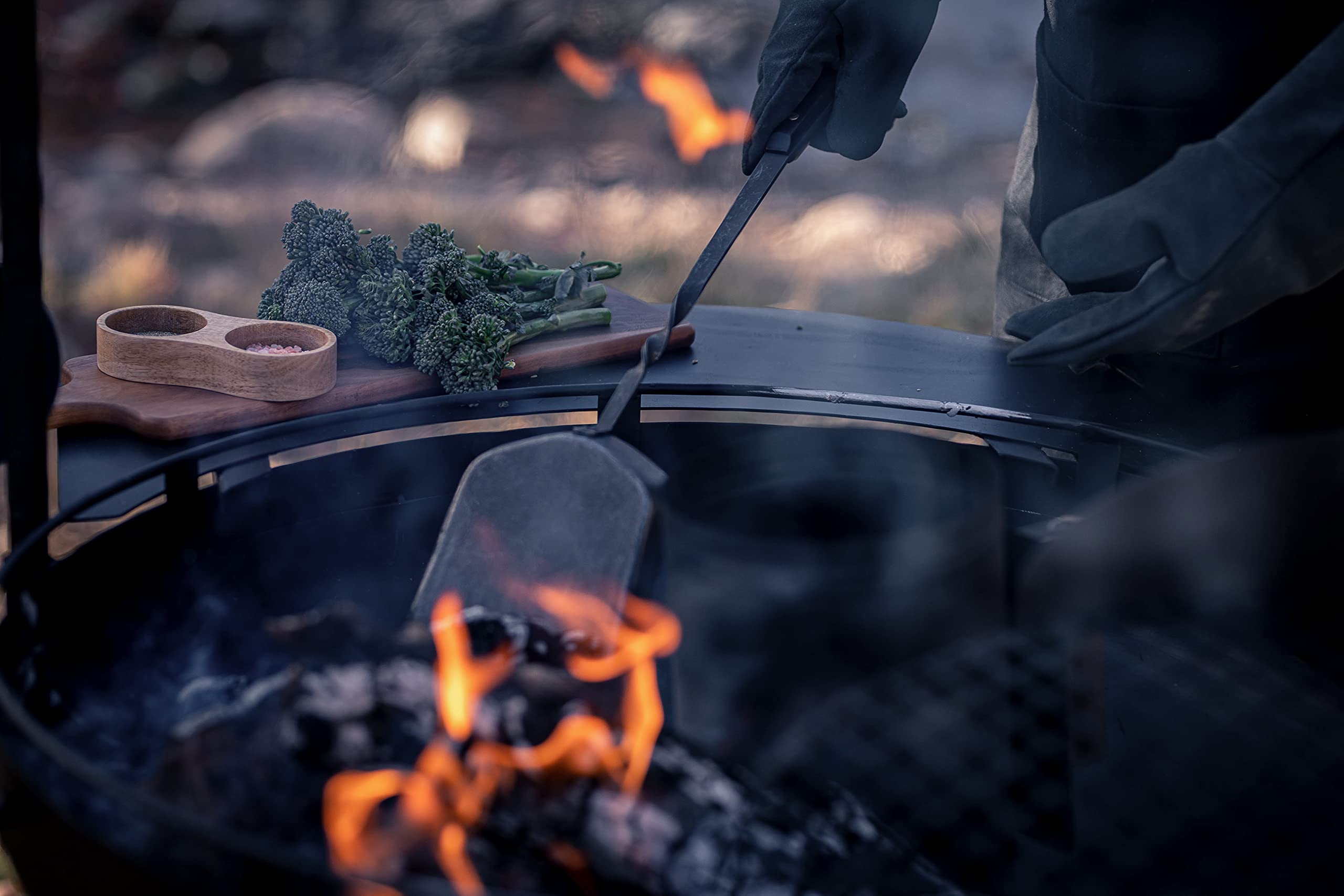 Barebones shovel leaning by campfire showing stylish utility for outdoor gatherings