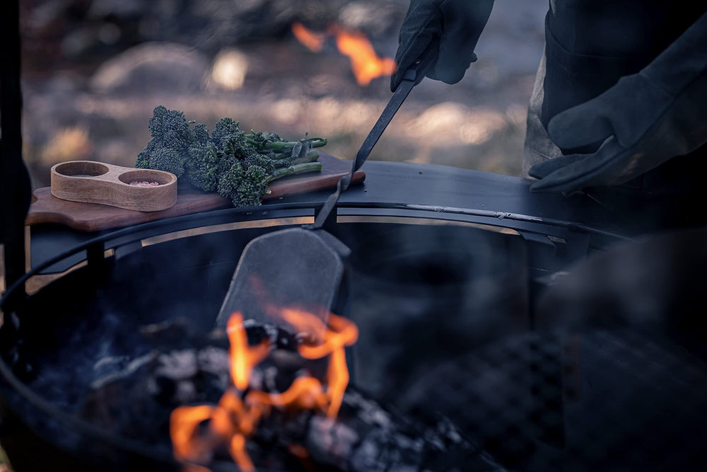 Barebones shovel leaning by campfire showing stylish utility for outdoor gatherings