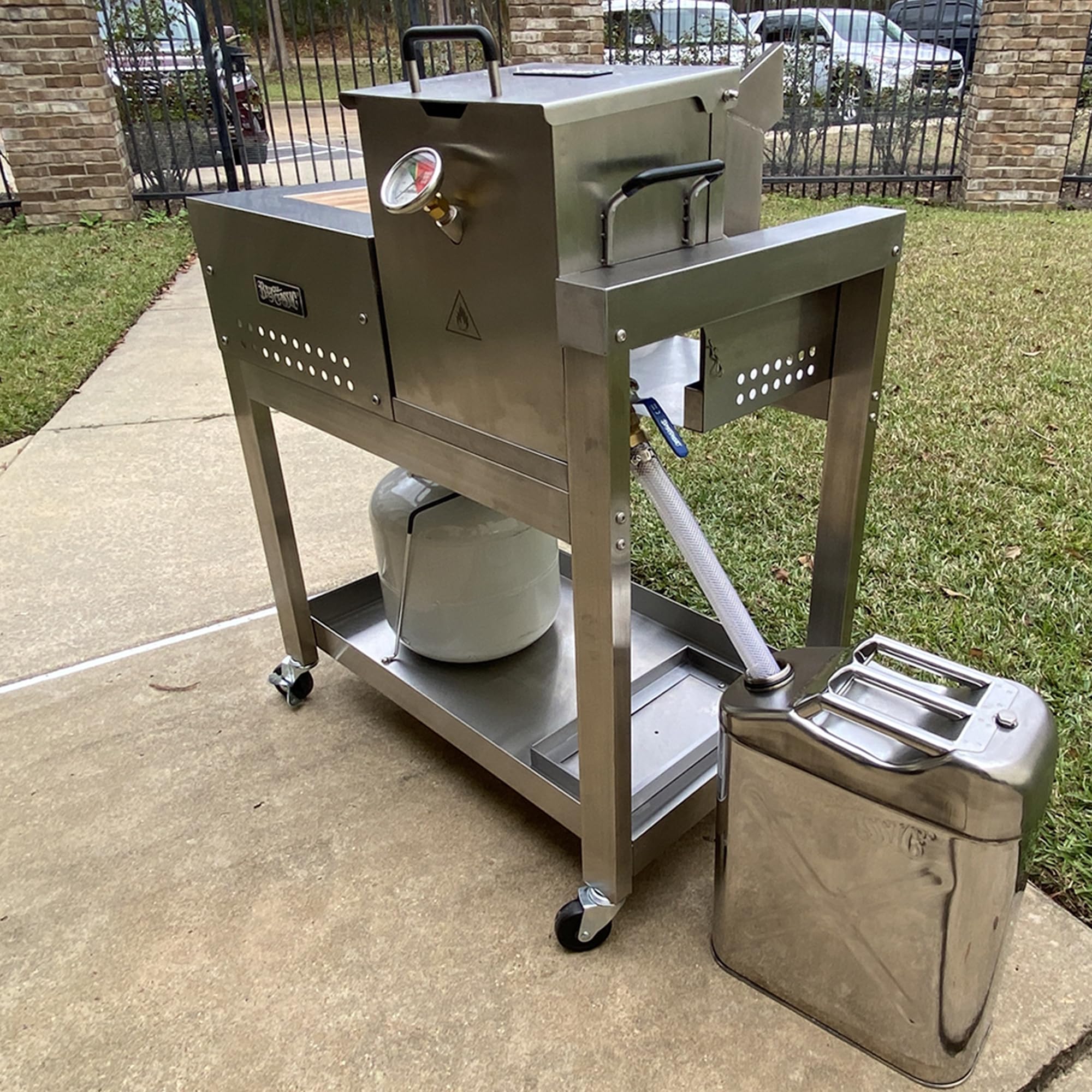 Bayou Classic hose directing oil into storage can for tidy cleanup