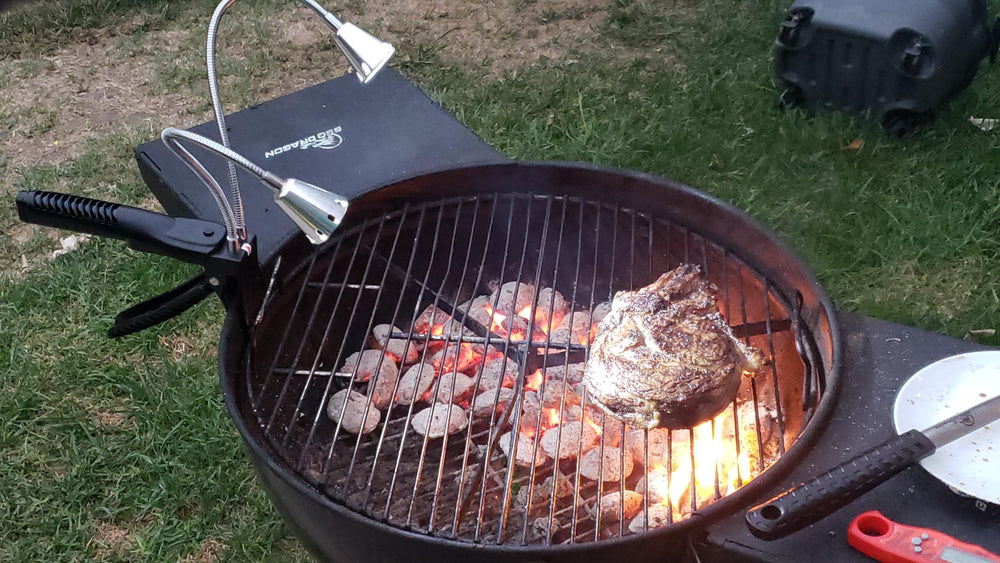 BBQ Dragon beside a spatula for scale, showing compact portability and reach benefit