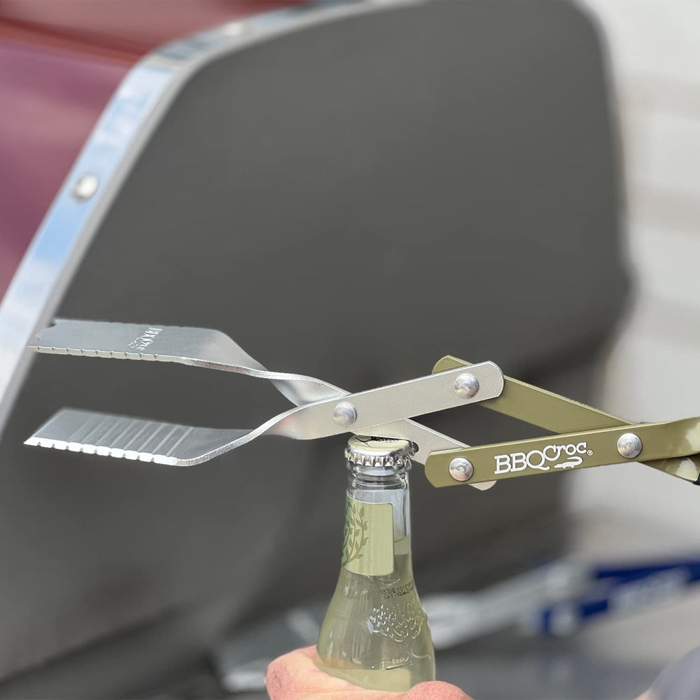 BBQCroc flipping a burger on a hot grill demonstrating secure grip