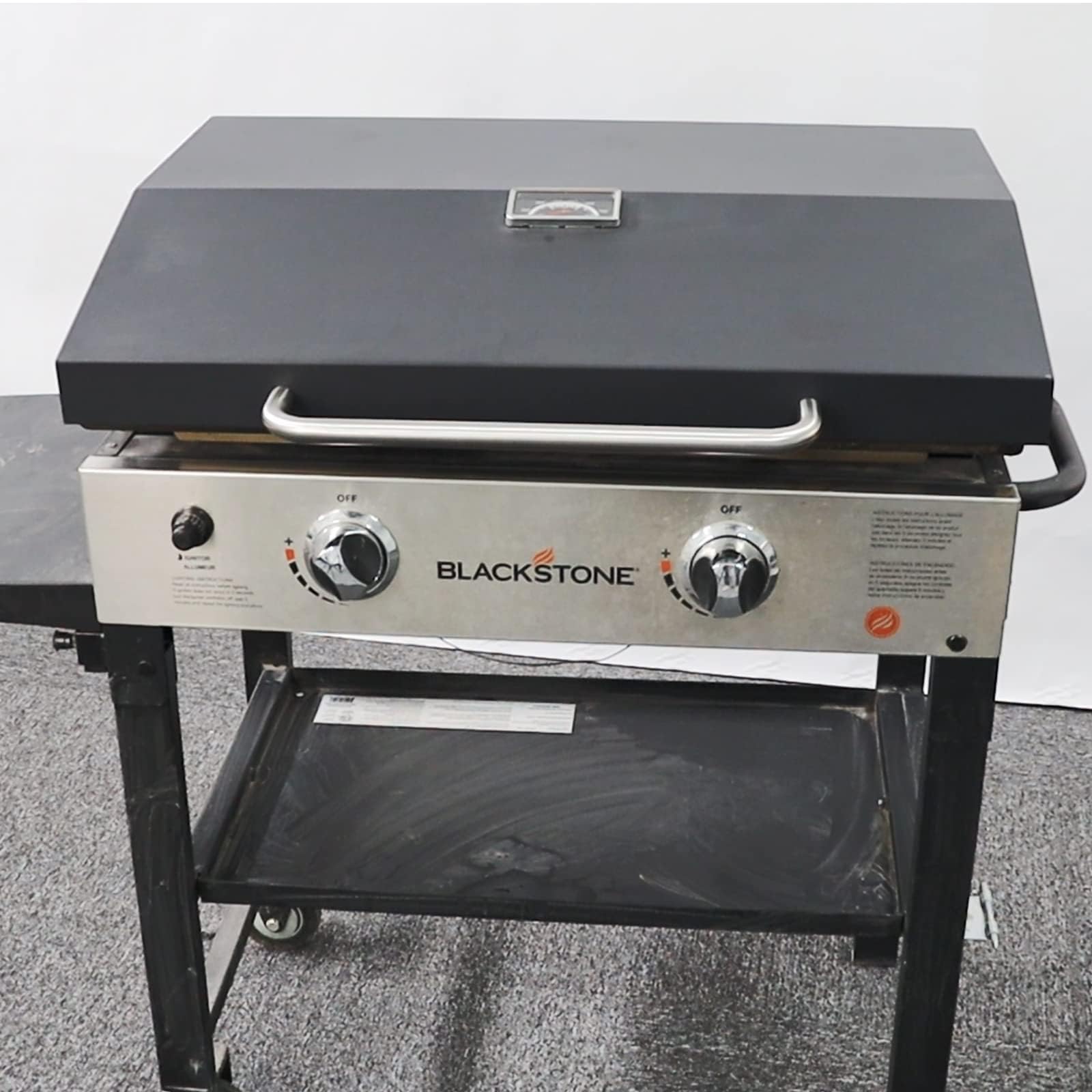 BBQration lid open from front demonstrating hands-free access while cooking
