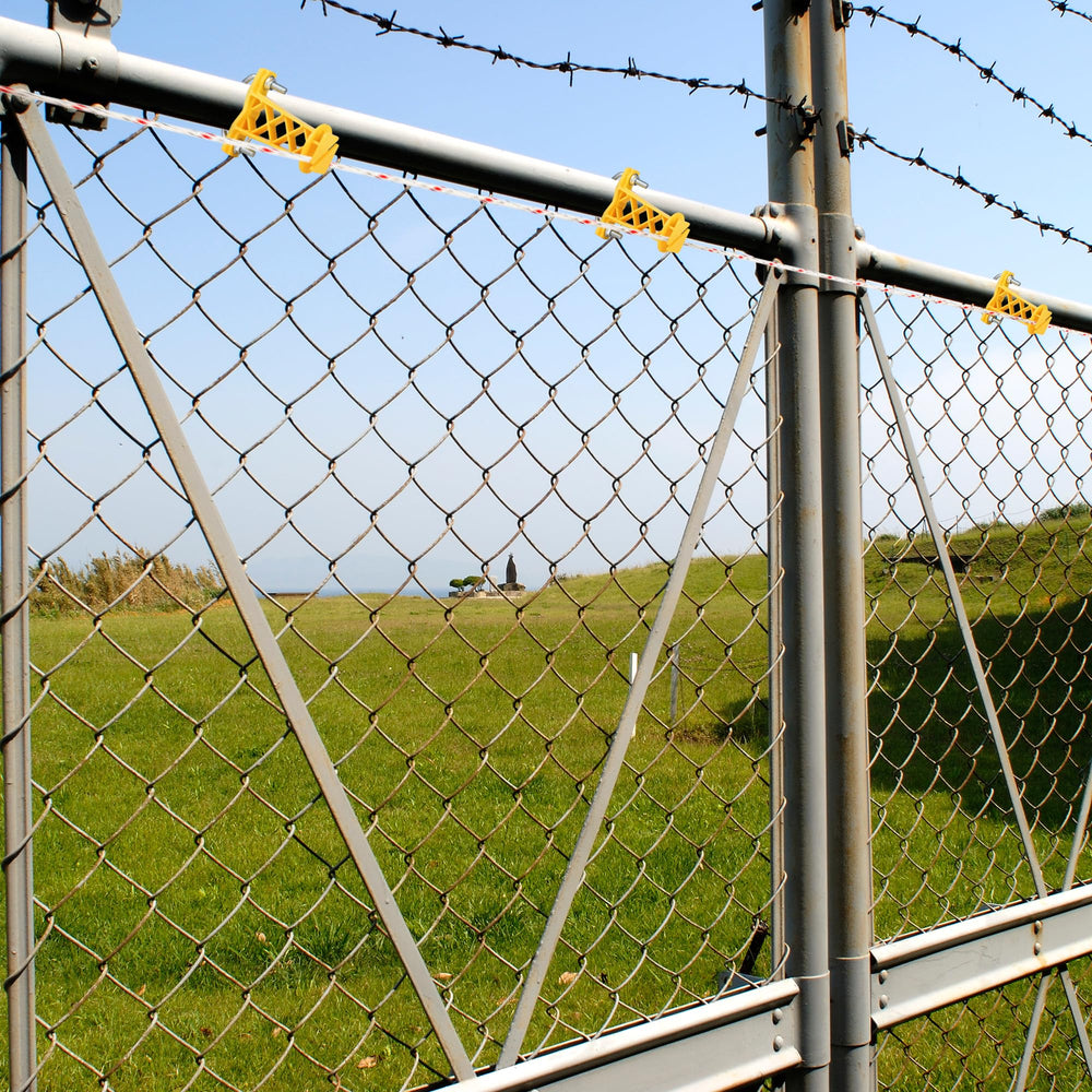 BEIYI insulators installed on a pasture fence showing easy installation and improved fence reliability