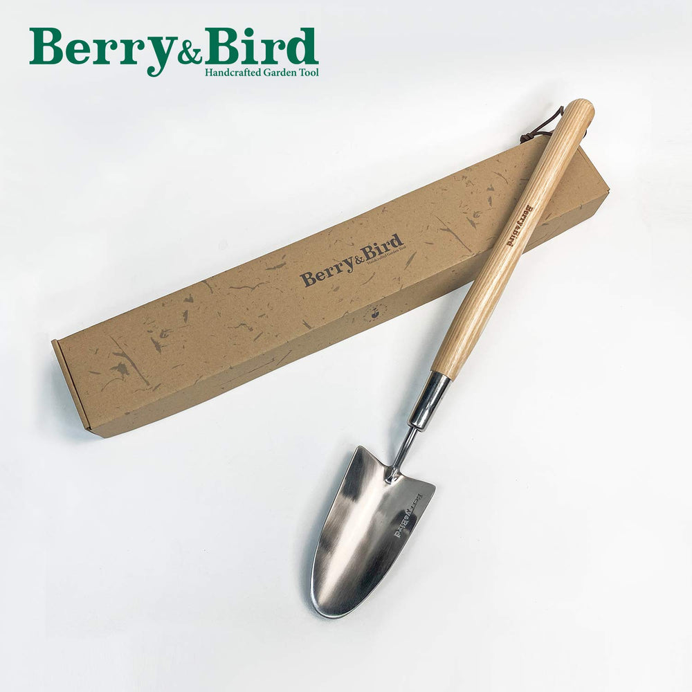 Berry&Bird trowel staged in garden setting illustrating comfortable long-handle use