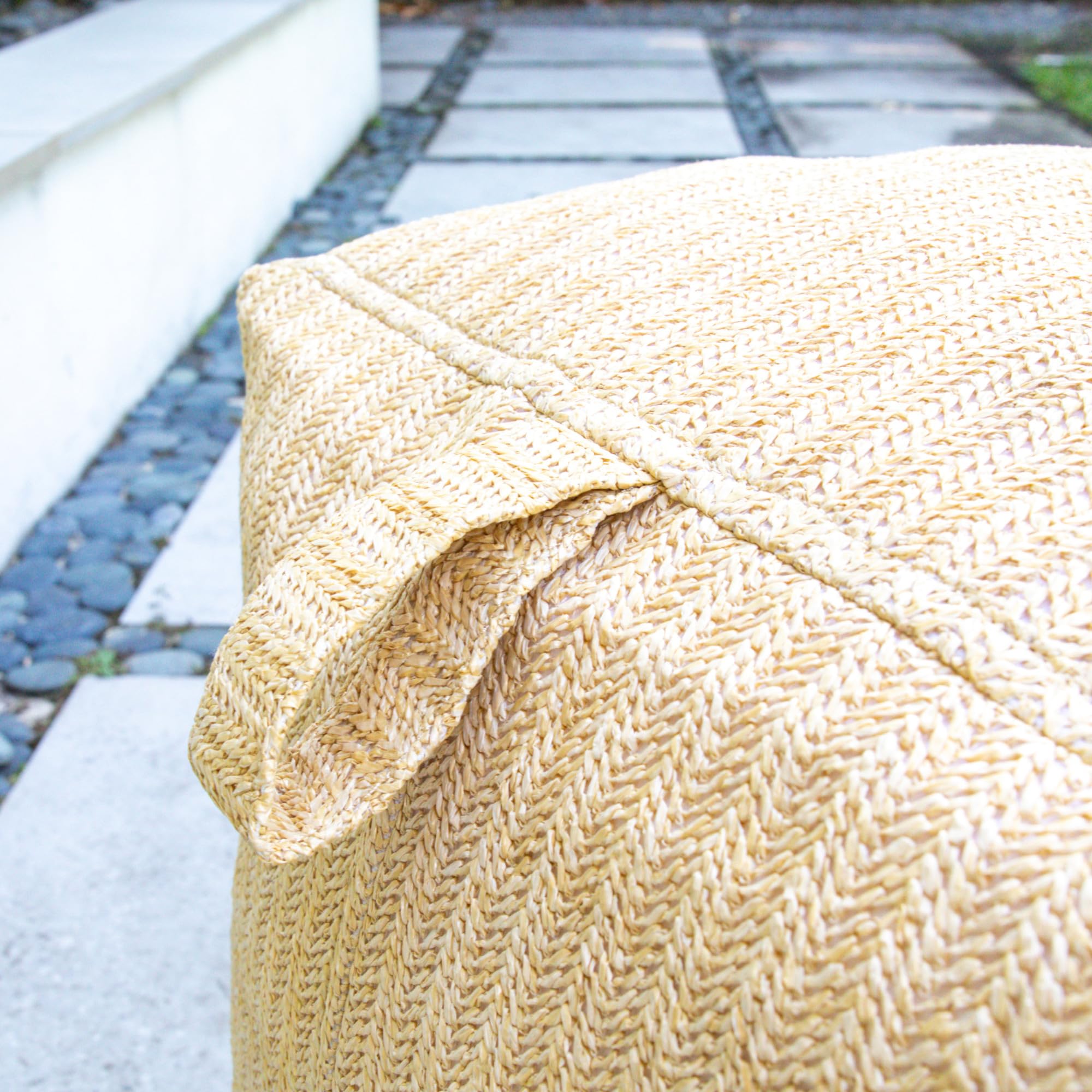Big Joe square ottoman on patio styled with cushions showing coordinated decor benefit