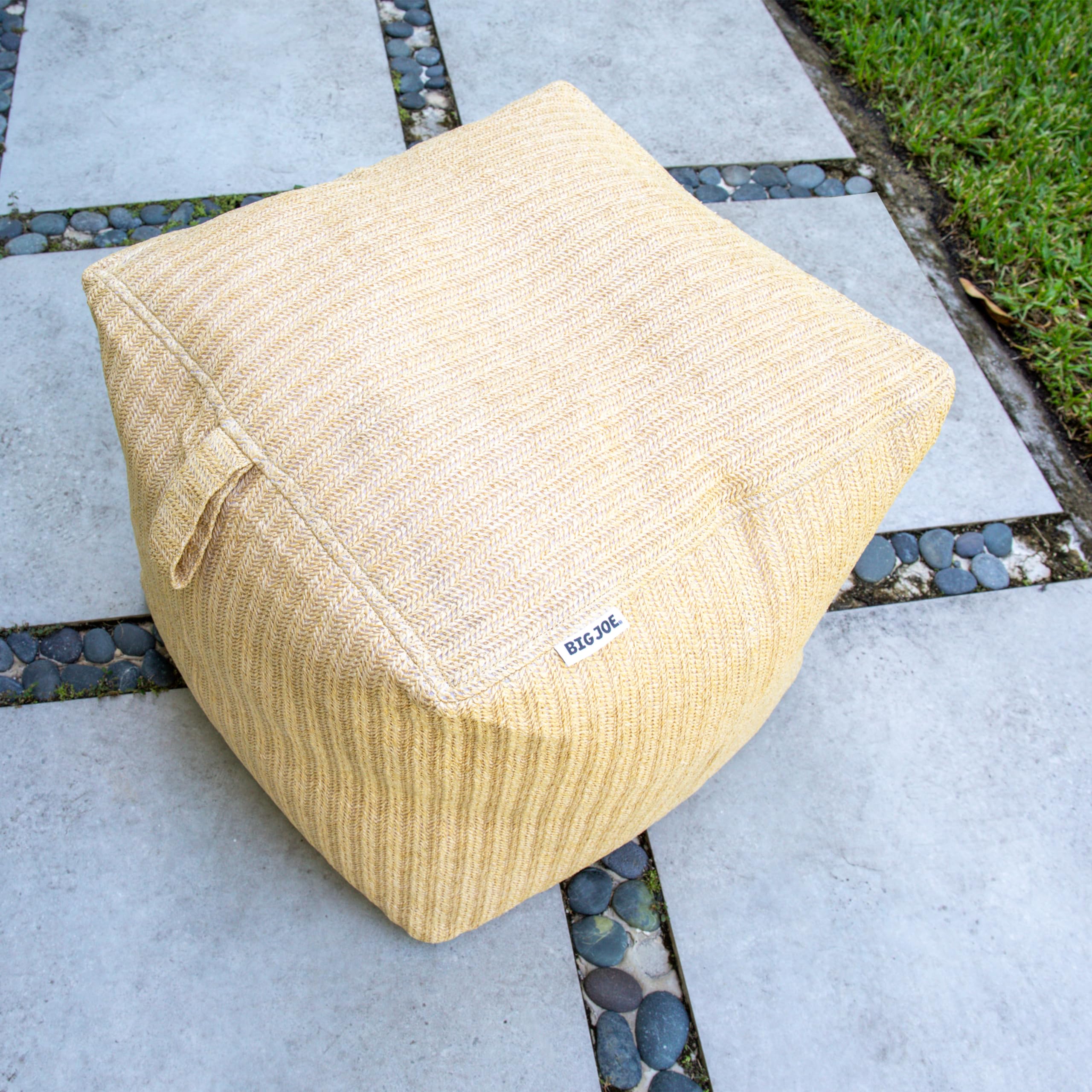 Big Joe ottoman beside chair showing two-foot scale and space-saving benefit