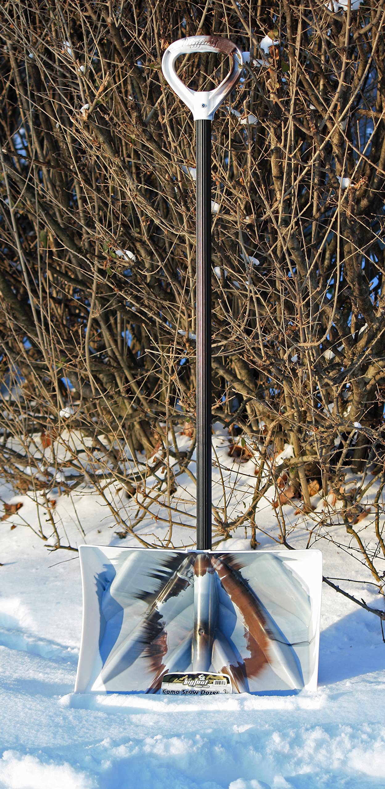 Bigfoot scoop action lifting deep snow to show large holding capacity