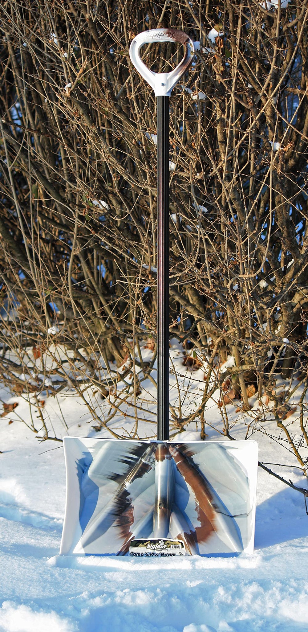Bigfoot scoop action lifting deep snow to show large holding capacity
