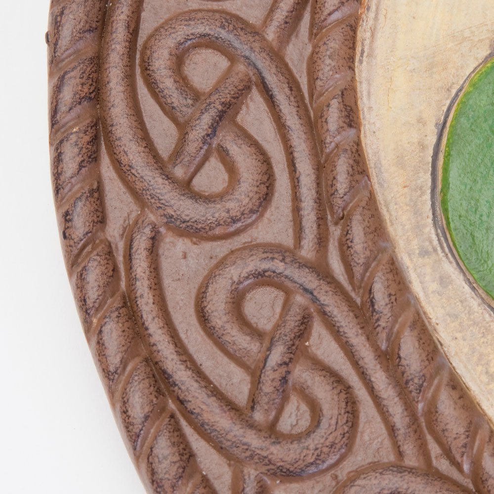 Bits and Pieces shamrock next to a hand illustrating 10-inch size and lightweight handling