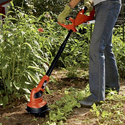 BLACK+DECKER laid out contents showing battery, charger, tines, and cultivator