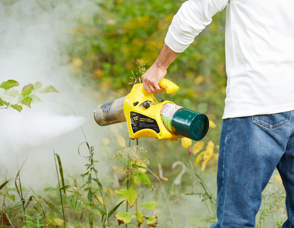 Black Flag fogger in use over a backyard patio demonstrating fast insect clearing