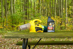 Black Flag fogger next to a hand showing compact size and easy portability