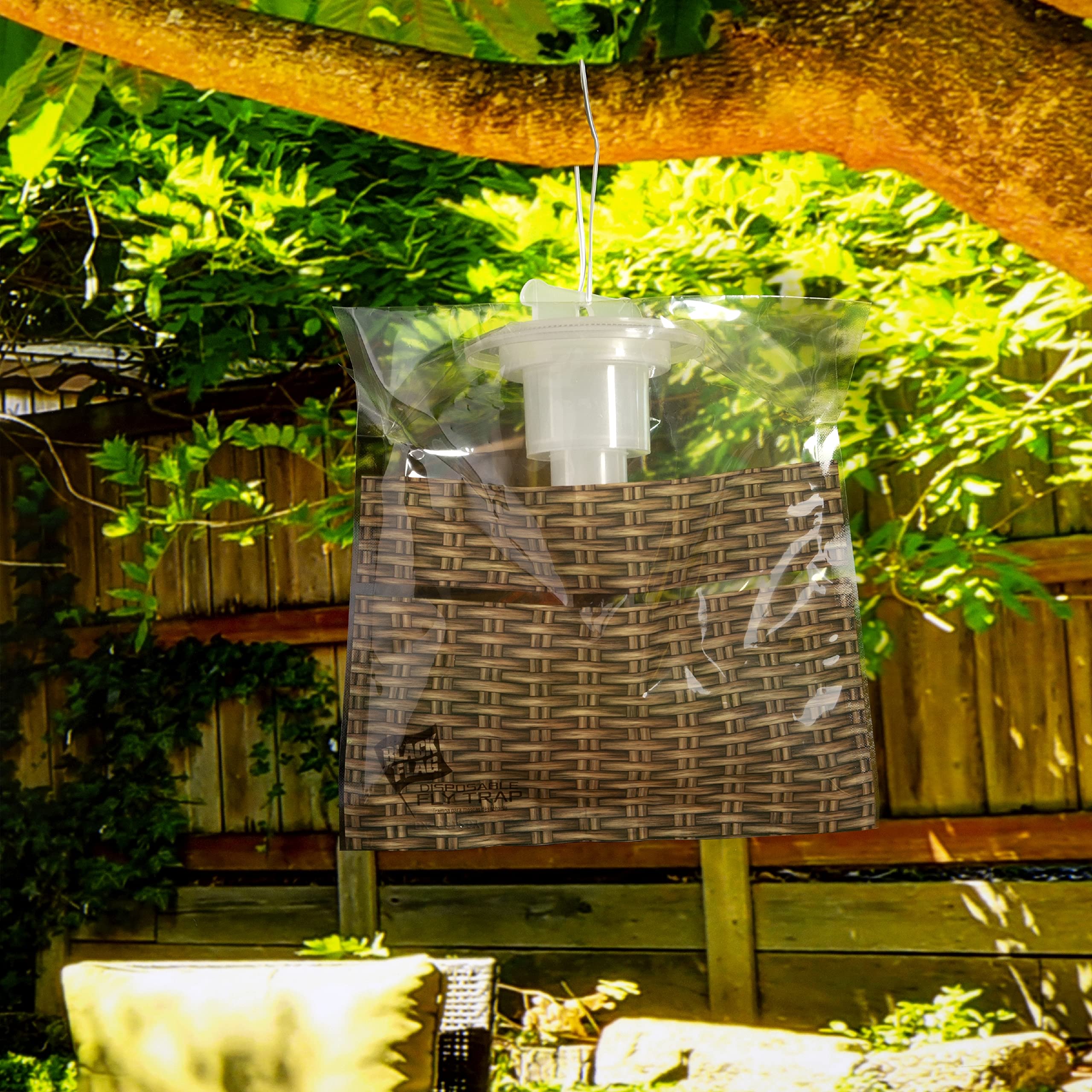 Black Flag trap held in hand for scale showing compact, discreet size