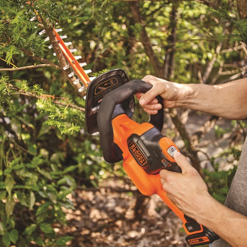 BLACK+DECKER blade cutting through branch demonstrating POWERCUT power
