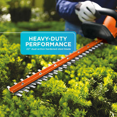 BLACK+DECKER hedge trimmer in use vertically demonstrating reach and ergonomic balance